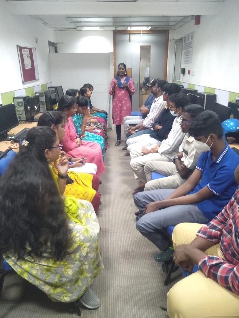 Participants sitting in two columns and a trainer is standing in between