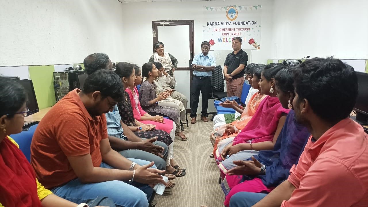 employers are seen standing and interacting with visually impaired students