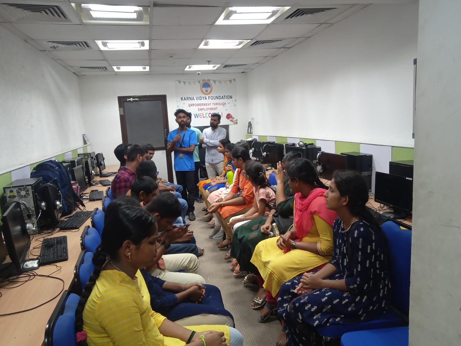 Participants sitting in two columns and trainer in between