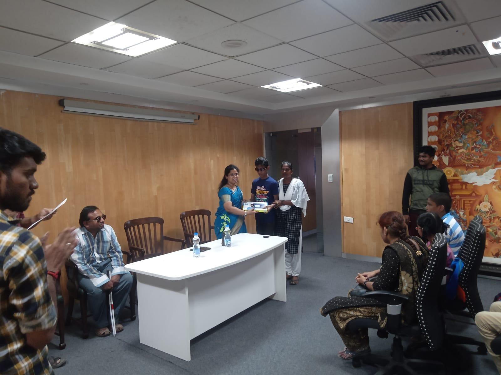 Participants sitting as audience and one participant receiving certificates from the dignitary